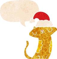 cute cartoon cat wearing christmas hat and speech bubble in retro textured style vector