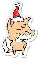 friendly distressed sticker cartoon of a fox wearing santa hat vector
