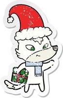distressed sticker of a friendly cartoon christmas wolf vector