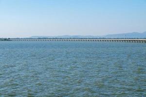 The long concrete bridge of the railway line across the large reservoir. photo