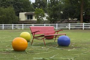 European red vintage iron chairs set in a park for leisure or exercisers to sit and relax in the garden with ceramic stone garden decoration designed by the garden. specifically photo