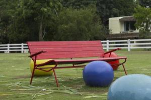 European red vintage iron chairs set in a park for leisure or exercisers to sit and relax in the garden with ceramic stone garden decoration designed by the garden. specifically photo