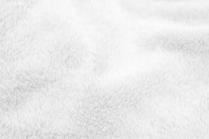 White clean wool texture background. light natural sheep wool. white seamless cotton. texture of fluffy fur for designers. close-up fragment white wool carpet. photo