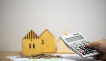 concept of money and finance to calculate income and expenses Pile of coins on graph paper on the table. Save money to buy a house. photo