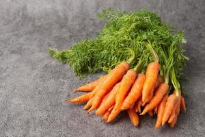 Fresh carrot on stone background. photo