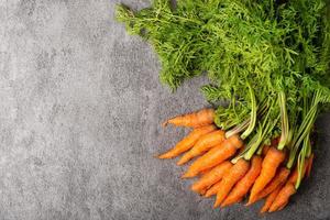 Baby carrot on stone background photo