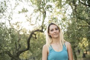 blonde girl in the countryside in backlight photo