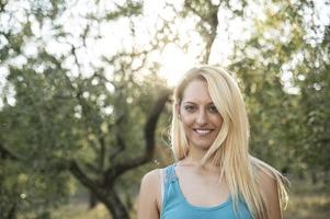 blonde girl in the countryside smiles photo