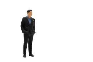 Miniature people businessman wearing black suit with clipping path photo