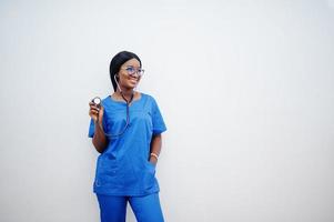 Portrait of happy female african american young doctor pediatrician in blue uniform coat and stethoscope isolated on white. Healthcare, medical, medicine specialist - concept. photo