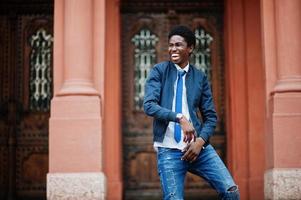 African man wear in tie and casual outfit posing outdoor. photo