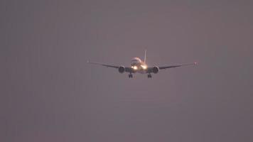 Widebody airplane approaching before landing on the Phuket airport against sunset sky. View from the top floor of the hotel near airport video