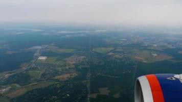 Airplane flying over the terrain, top view from the porthole video