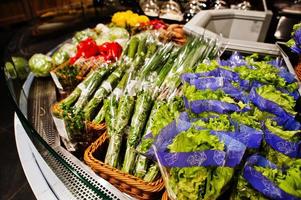 Salad bar with various fresh vegetables at supermarket. photo