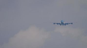 Long shot of widebody approaching before landing. Double deck airliner with four engines flies