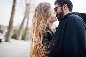 Cool multiracial couple hugs together, sincere emotions. photo