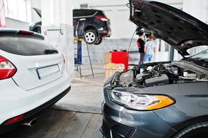 Car repair and maintenance theme. Cars in auto service. photo