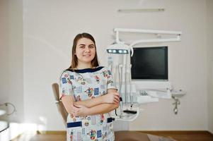 Portrait of baby dentist female at her dental office. photo