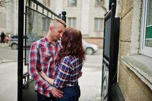 Stylish couple wear on checkered shirt in love together. photo