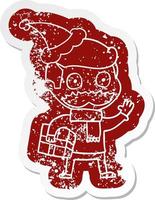 cartoon distressed sticker of a man with mustache and christmas present wearing santa hat vector