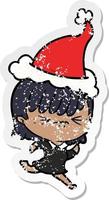 annoyed distressed sticker cartoon of a girl wearing santa hat vector