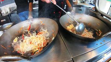 Noodles vegetables and meat tossed and cooked in a wok video