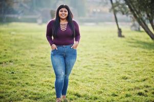 Pretty latino xxl model girl from Ecuador wear on violet blouse posed at street. photo