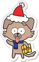 pegatina, caricatura, de, un, perro, con, regalo de navidad, llevando, santa sombrero vector