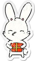 distressed sticker of a curious bunny cartoon with present vector