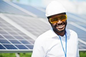 African american technician check the maintenance of the solar panels. Black man engineer at solar station. photo