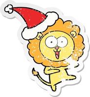 happy distressed sticker cartoon of a lion wearing santa hat vector