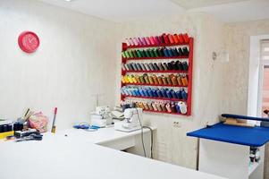 Workplace of seamstress office with sewing machine on table. photo