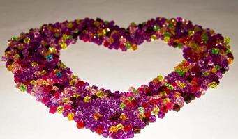 Beads arranged in a heart shaped. Heart drawn with arrangements of beads photo