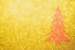 Abstract Gold glitter festive with red Christmas tree texture background blur with bokeh light photo