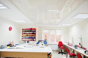 Workplace of seamstress office with sewing machine on table. photo