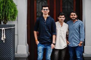 Group of three indian mans, wear on casual clothes, posed outdoor at street of India. photo