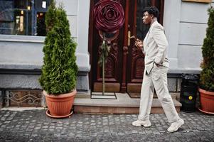 Stylish afro man in beige old school suit. Fashionable young African male in casual jacket on bare torso. photo