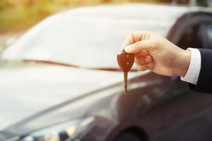 Car key, businessman handing exchange over give to the other man. Seller dealer credit Interest payment or purchase by installment car concept. photo