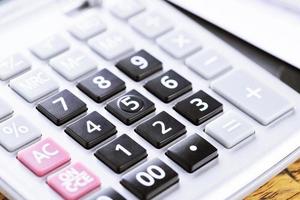 close up calculator focus at on press button keyboard. concept calculate account finance. photo