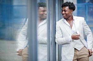 Thoughtful young handsome african american gentleman in formalwear. Black stylish model man in white jacket. photo