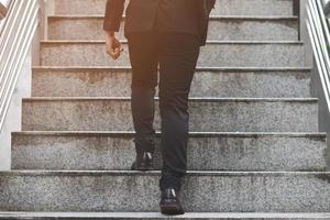 modern businessman working close-up legs walking up the stairs in modern city. in rush hour to work in office a hurry. During the first morning of work. stairway photo