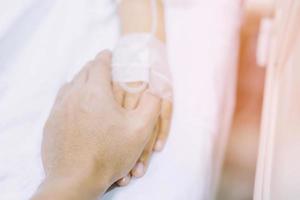 Focus on the hand of a patient in hospital ward photo