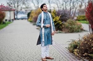 Indian man wear on traditional clothes with white scarf posed outdoor. photo