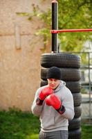 Man arabian boxer in hat training for a hard fight outdoor gym. photo