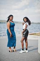 Two african american dark skinned friends female. One of them plus size model, second slim. Having fun and spending time together. photo