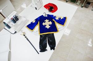 Children's carnival hand made boy costume at seamstress office on workplace. photo