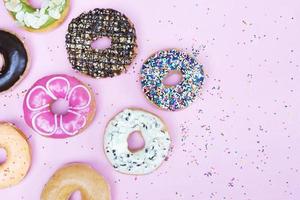 assorted donuts with chocolate frosting, topping sprinkles photo