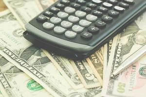 Money and calculator on financial data bar photo