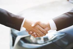 auto business. Close up of a business man dealer offer car to new owner photo