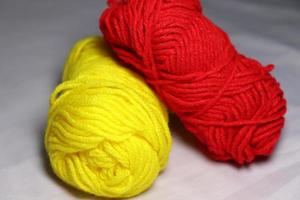 red and yellow colored yarn closeup photo